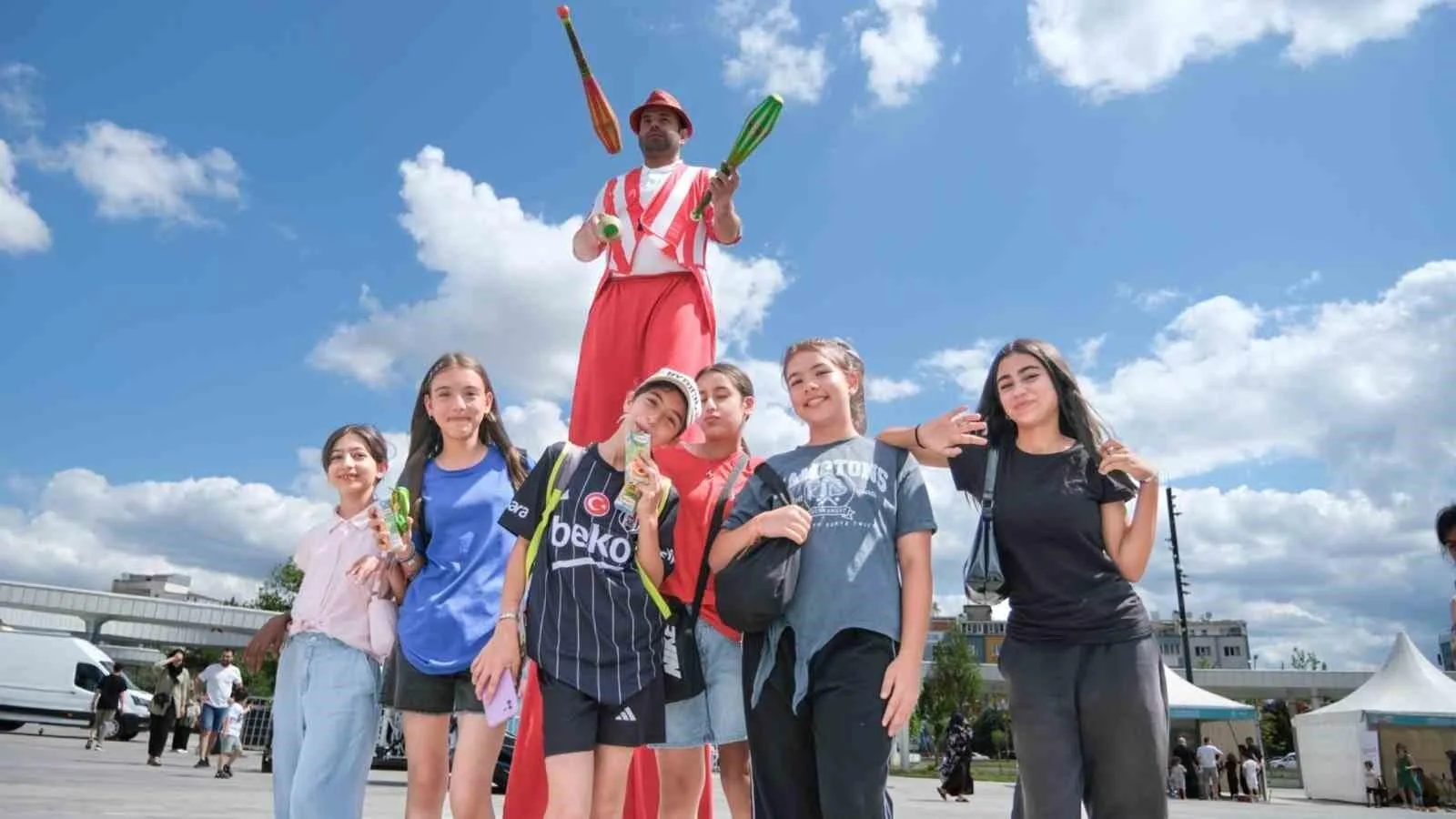 Colorful street performer entertaining children at Istanbul local event, creating lively city atmosphere.