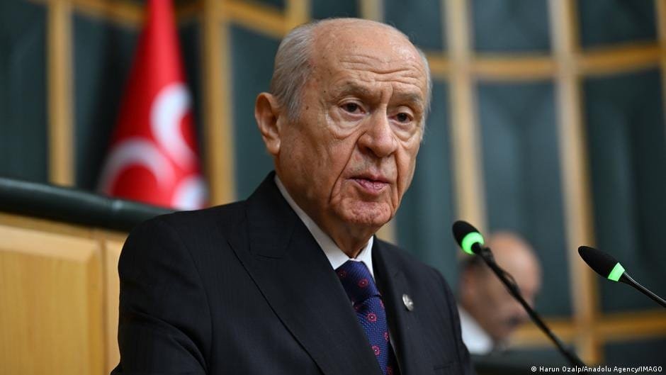 Devlet Bahçeli speaking at a political event, MHP leader discussing party reactions.