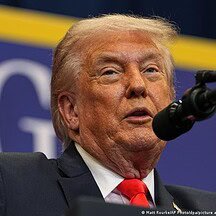 Donald Trump speaking at a political event, emphasizing his influence on European and American relat.